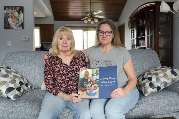 Boni Speer, left, and her daughter, Tracy Balhan, hold a photo of Bill Speer