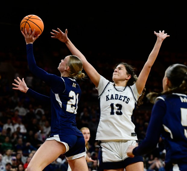Mary Jane Archibald (21) of the Mullen Mustangs lays up a shot against Ramah Khammash (13) of the Air Academy Kadets in the first half of the state high school girls Class 5A championship game at the Denver Coliseum in Denver on Saturday, March 15, 2025. (Photo by Andy Cross/The Denver Post)