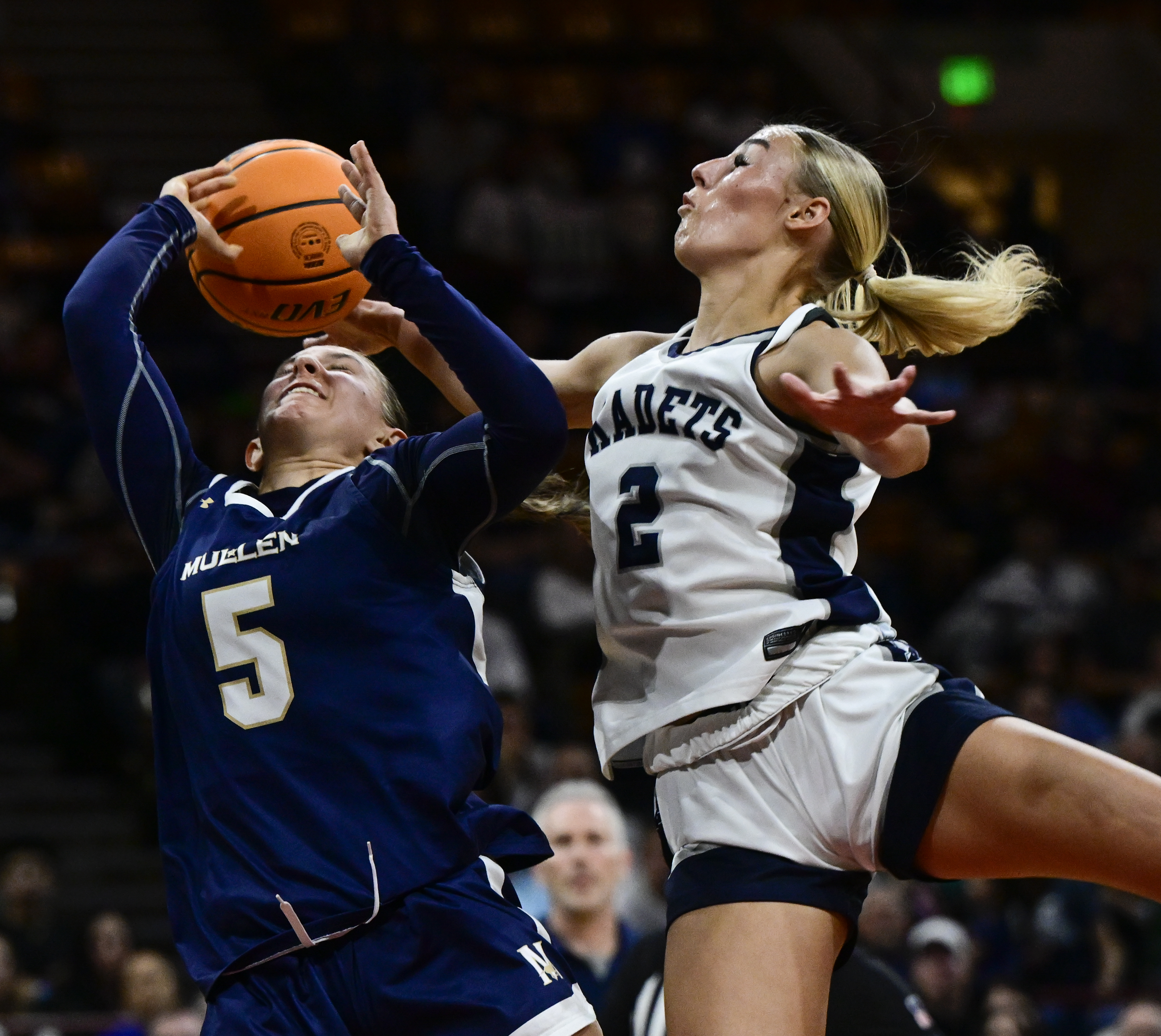 Kinley Asp (2) of the Air Academy Kadets, right, swats the ball away from Keaton Arangua-Egbert (5) of the Mullen Mustangs in the first half of the state high school girls Class 5A championship game at the Denver Coliseum in Denver on Saturday, March 15, 2025. (Photo by Andy Cross/The Denver Post)
