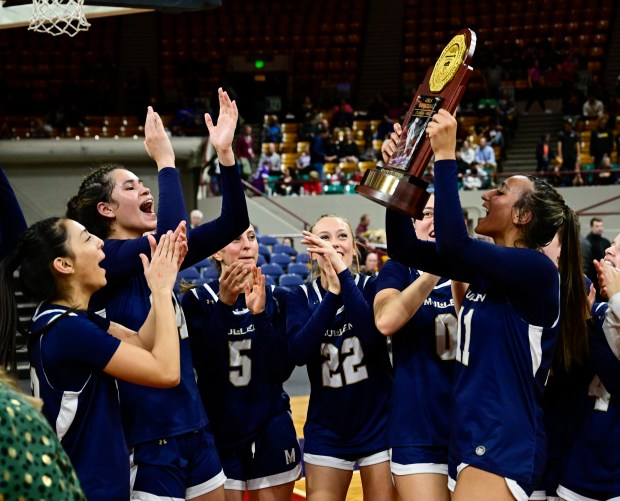 Makenzie Jones (11) of the Mullen Mustangs, right, hoists the championship trophy and celebrates with the team after defeating the the Air Academy Kadets 56-42, winning the state high school girls Class 5A championship game at the Denver Coliseum in Denver on Saturday, March 15, 2025. (Photo by Andy Cross/The Denver Post)