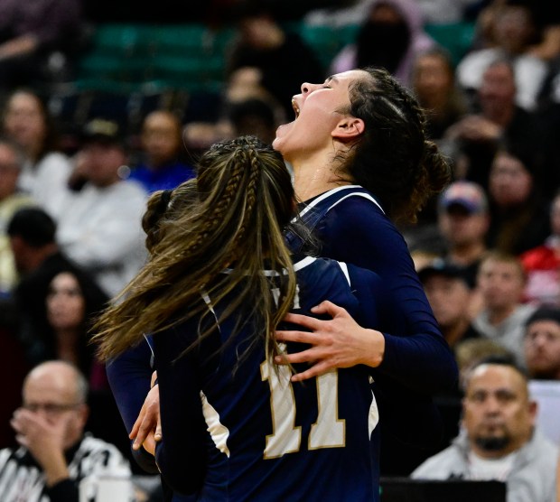 Tatum Jones (24) of the Mullen Mustangs, right, and teammate Makenzie Jones (11) celebrate after defeating the the Air Academy Kadets 56-42, winning the state high school girls Class 5A championship game at the Denver Coliseum in Denver on Saturday, March 15, 2025. (Photo by Andy Cross/The Denver Post)
