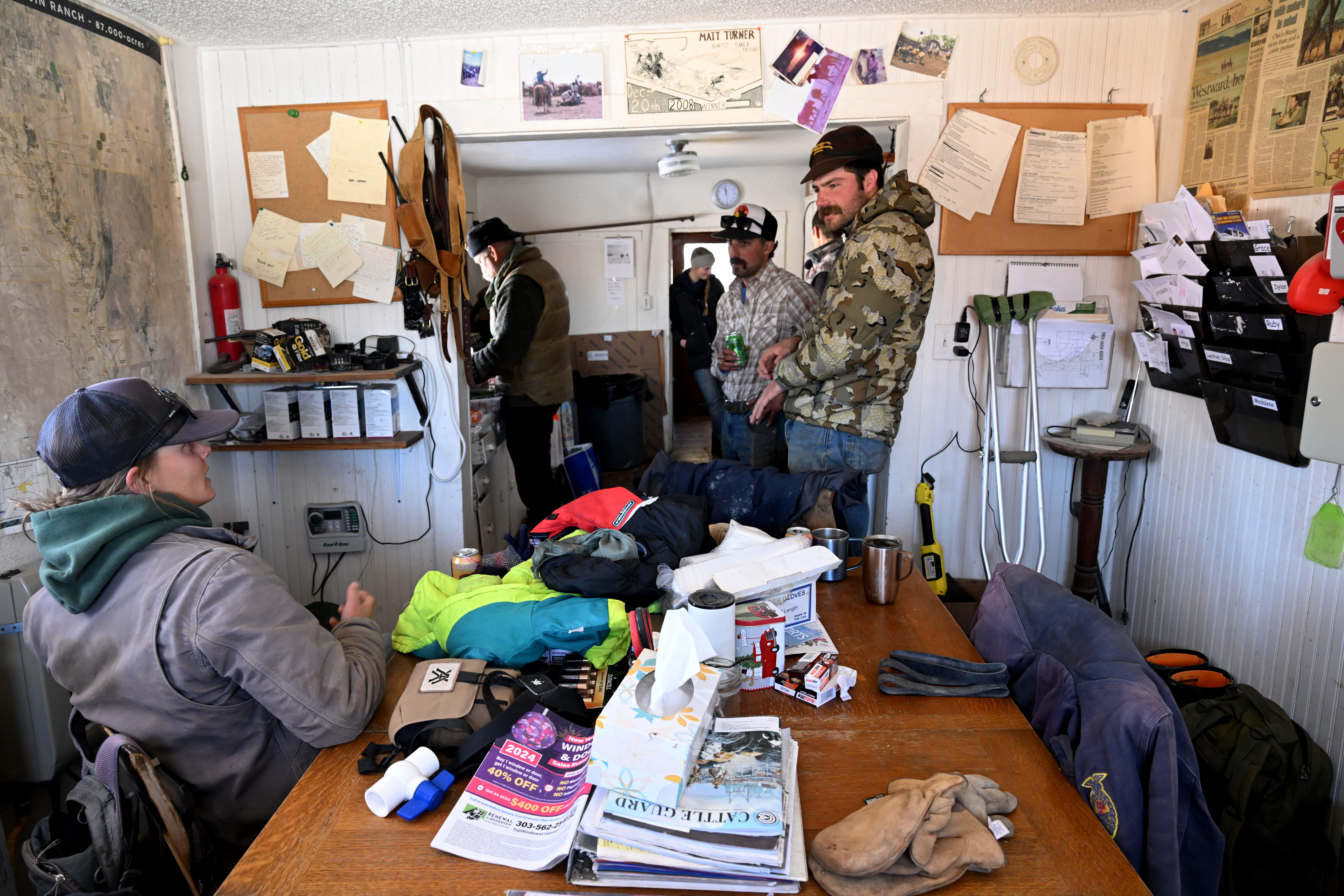 Apprentices Anja Stokes, left, and Dylan Taylor, right, and managing apprentice Mike Giordano, center, take a break for lunch during pregnancy checks of cows at Chico Basin Ranch on Jan. 5, 2024. (Photo by Helen H. Richardson/The Denver Post)