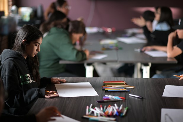 Camila Chavez, 13, works on a magazine project the at Convivir Moonshot office in Denver on Tuesday, April 1, 2025. (Photo by Hyoung Chang/The Denver Post)