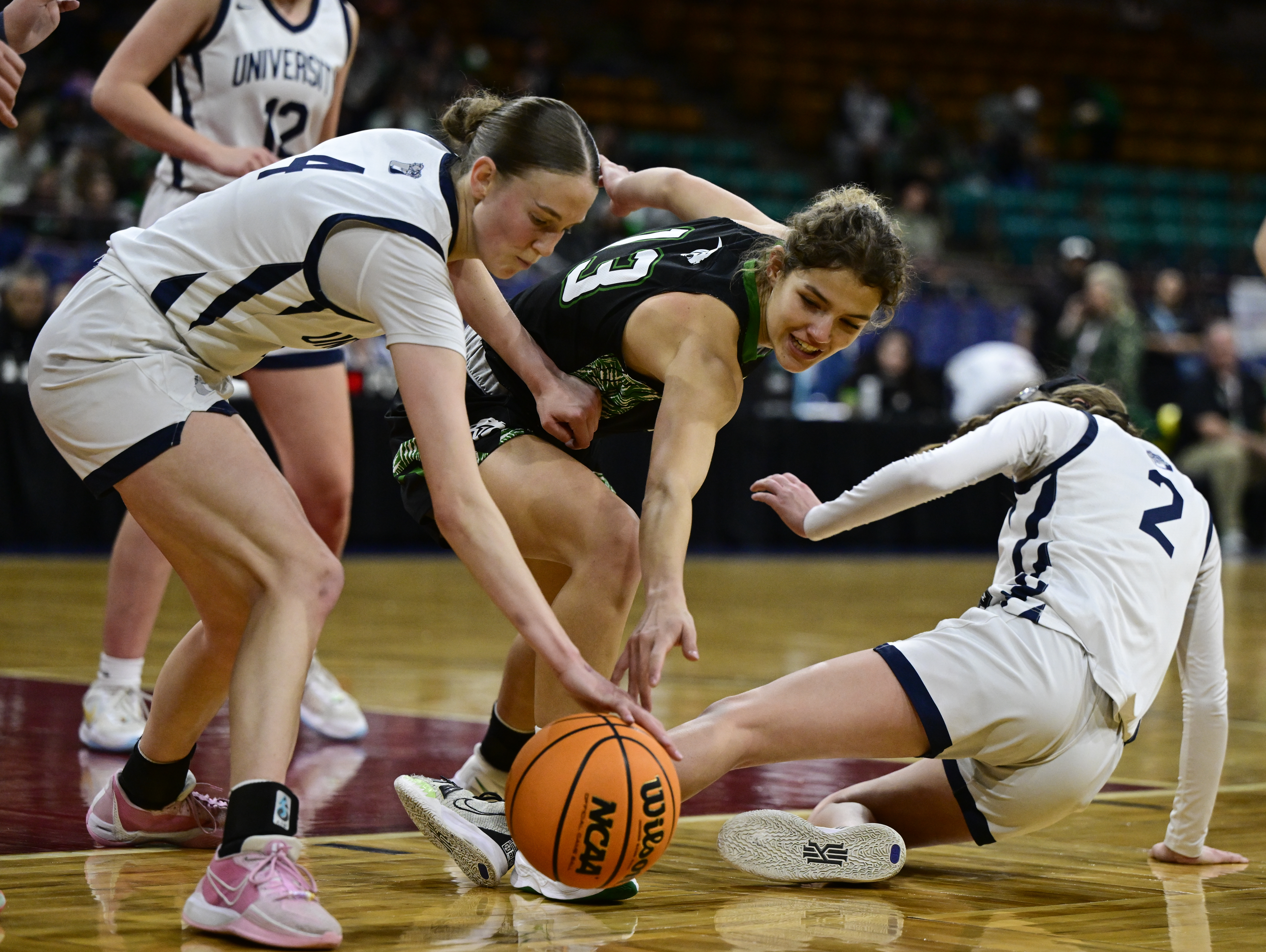 Janay Kravig (4) of the University Bulldogs, left, and Breezy Huff (13) of the Delta Panthers get after a loose ball in the first half of the state high school girls 4A championship game at the Denver Coliseum in Denver on Saturday, March 15, 2025. (Photo by Andy Cross/The Denver Post)