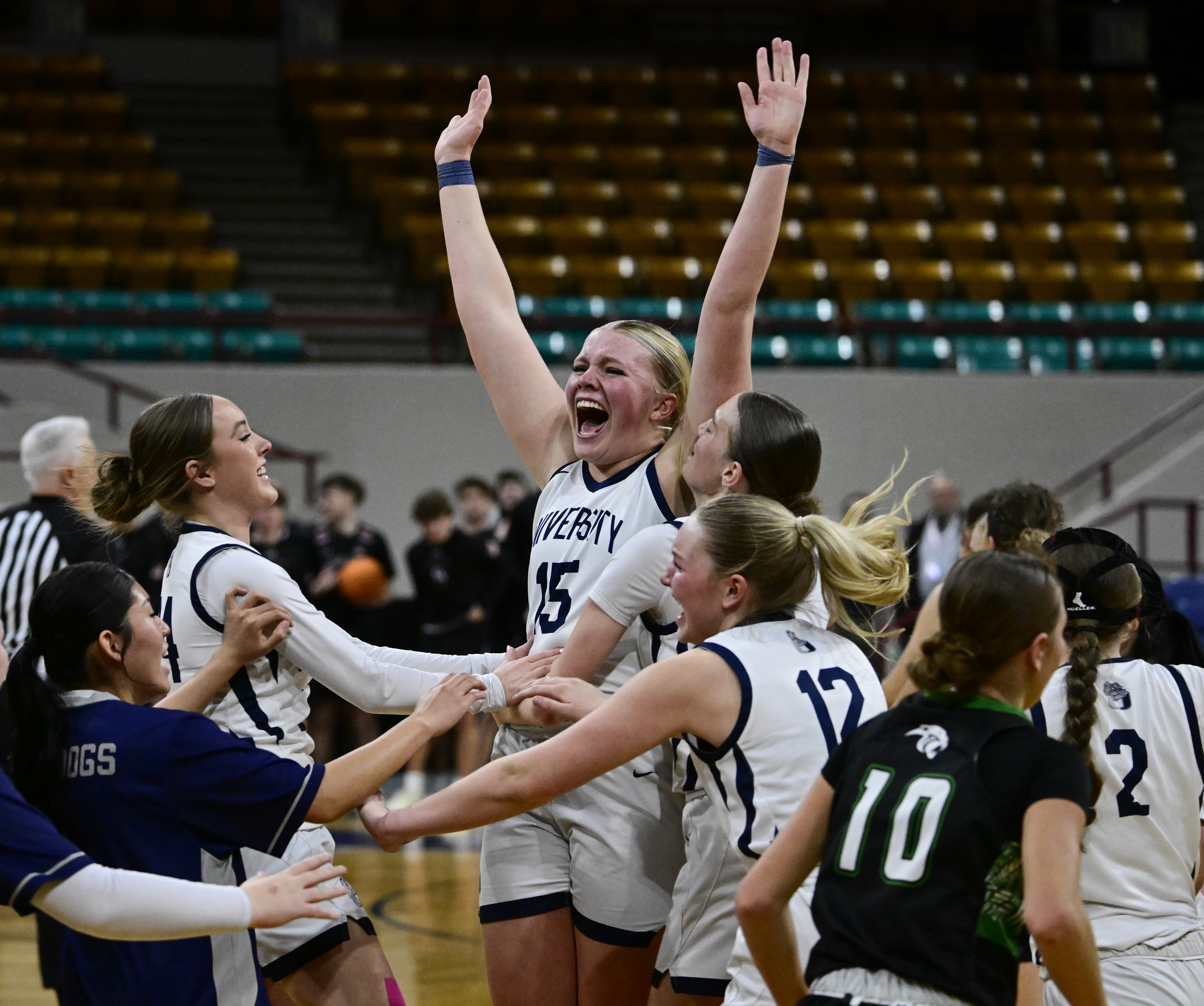 Addison Harding (15) of the University Bulldogs, surrounded by her teammate, celebrates after defeating the the Delta Panthers 42-35, winning the state high school girls 4A championship at the Denver Coliseum in Denver on Saturday, March 15, 2025. (Photo by Andy Cross/The Denver Post)