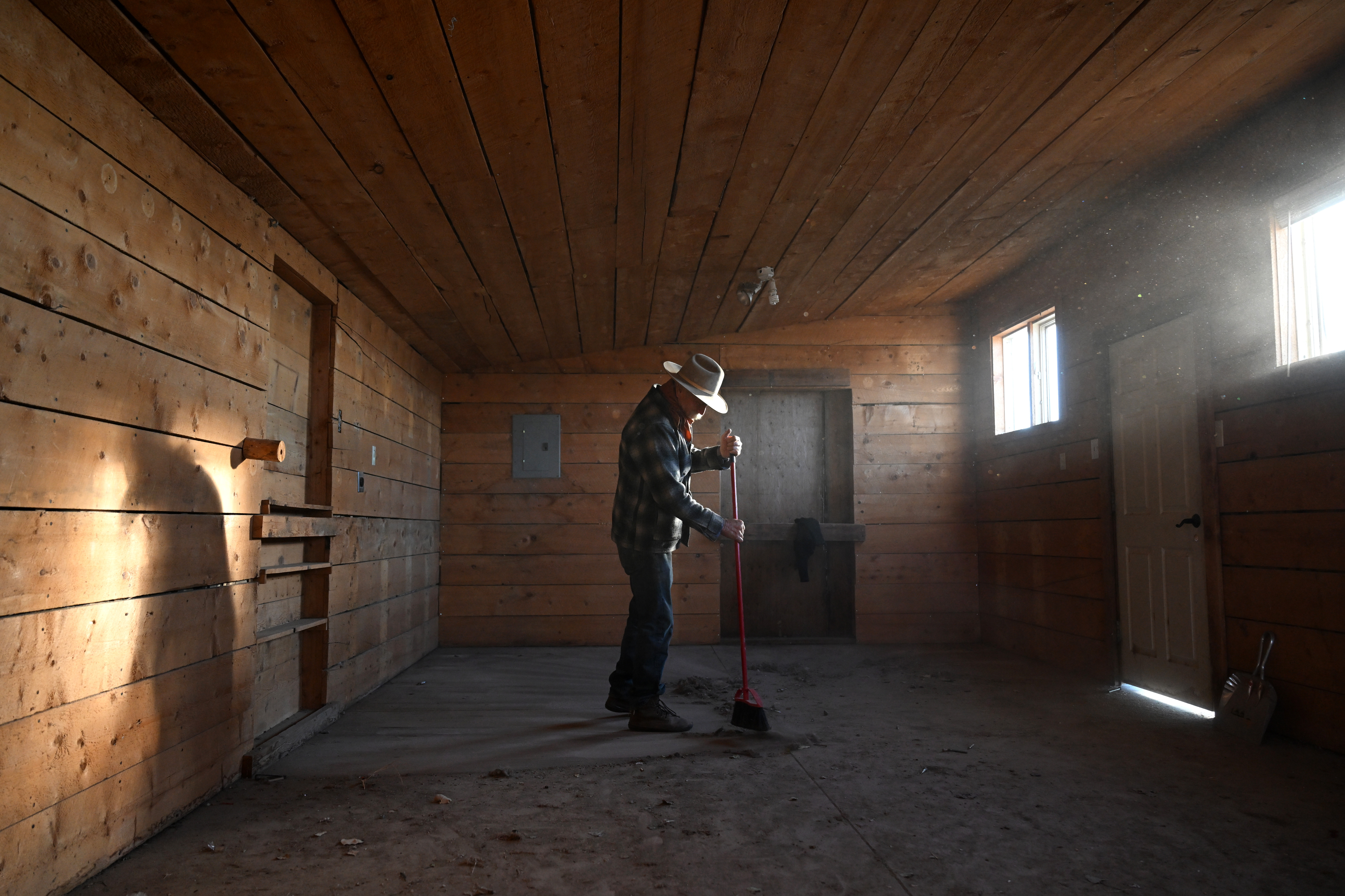 On one of the final days on the ranch, Duke Phillips III sweeps up in the empty building that once housed their leather shop at Chico Basin Ranch on Dec. 30, 2024. (Photo by Helen H. Richardson/The Denver Post)