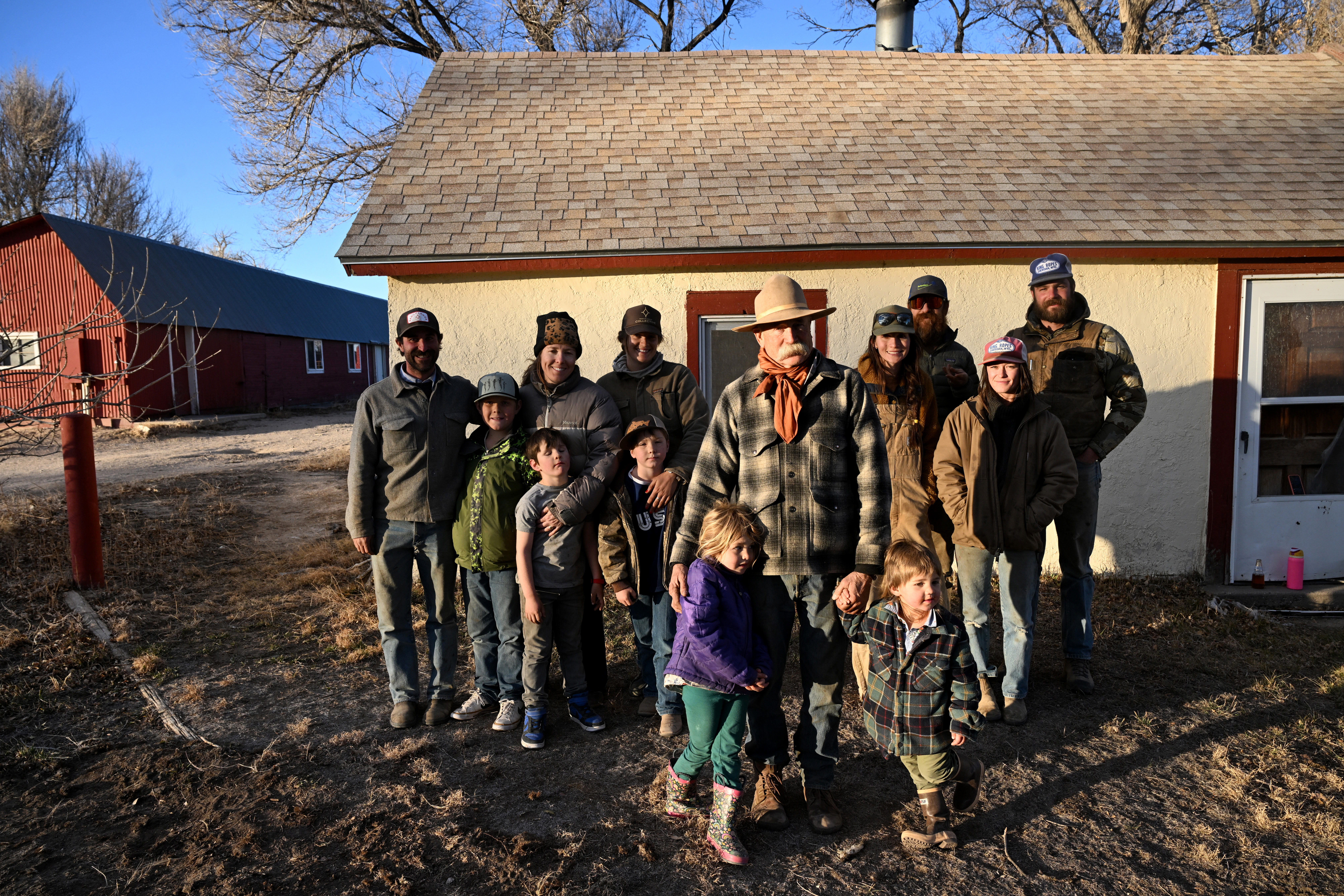 Three generations of the Phillips family on their last day on the Chico Basin Ranch, Dec. 30, 2024. In the photo are from left to right: Ranch hand Jack Howick, Woods Leach, 10, Knox Leach, 6, Tess Leach, Grace Phillips, Hayes Leach, 8, Duke Phillips III in front with grandchildren Dean Phillips, 4, and Duke V, 3, Madi Phillips, Duke Phillips IV, and apprentices Ruby Dunbar and Dylan Taylor. (Photo by Helen H. Richardson/The Denver Post)