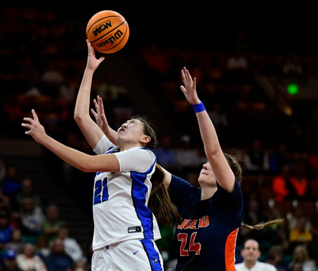 Ava Chang (21) of the Grandview Wolves lays up a shot against Aubrey Cook (24) of the Legend Titans in the second half of the state high school girls Class 6A championship game at the Denver Coliseum in Denver on Saturday, March 15, 2025. (Photo by Andy Cross/The Denver Post)