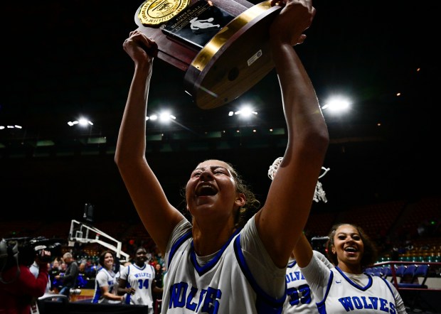 Sienna Betts (51) of the Grandview Wolves hoists the championship trophy after defeating the Legend Titans 61-39, winning the state high school girls Class 6A championship game at the Denver Coliseum in Denver on Saturday, March 15, 2025. (Photo by Andy Cross/The Denver Post)