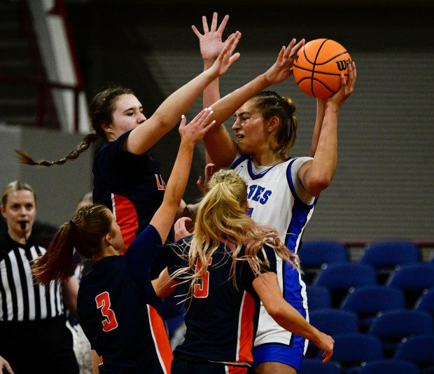 Sienna Betts (51) of the Grandview Wolves gets triple-teamed by Grace Stanley (3) of the Legend Titans and teammates Aubrey Cook (24) second from left, and Maley Wilhelm (5) in the first half of the state high school girls 6A championship game at the Denver Coliseum in Denver on Saturday, March 15, 2025. (Photo by Andy Cross/The Denver Post)