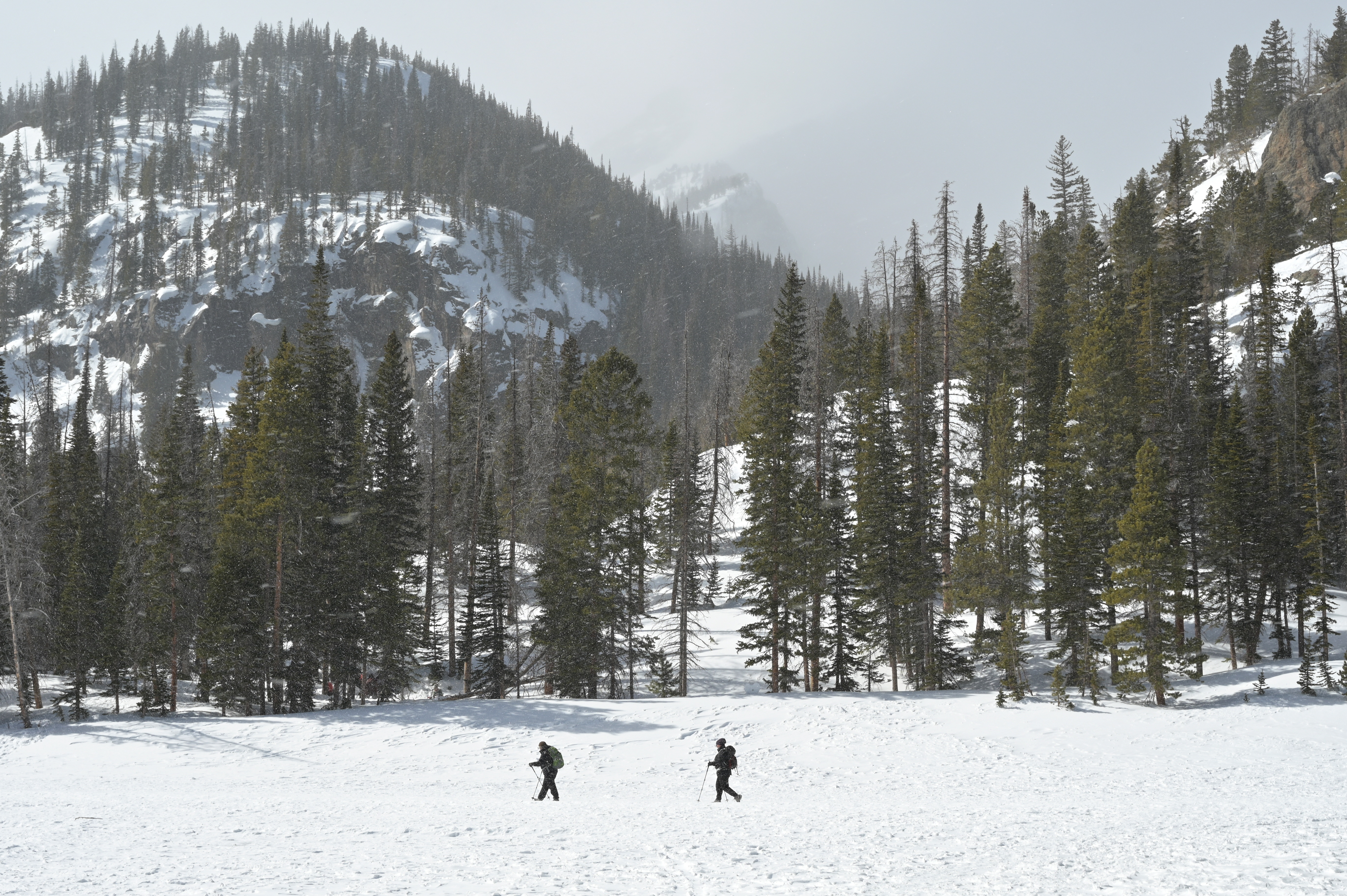 Hikers make their way around a snow covered Nymph Lake in Rocky Mountain National Park, Colorado, on Wednesday, March 5, 2025. (Photo by Hyoung Chang/The Denver Post)
