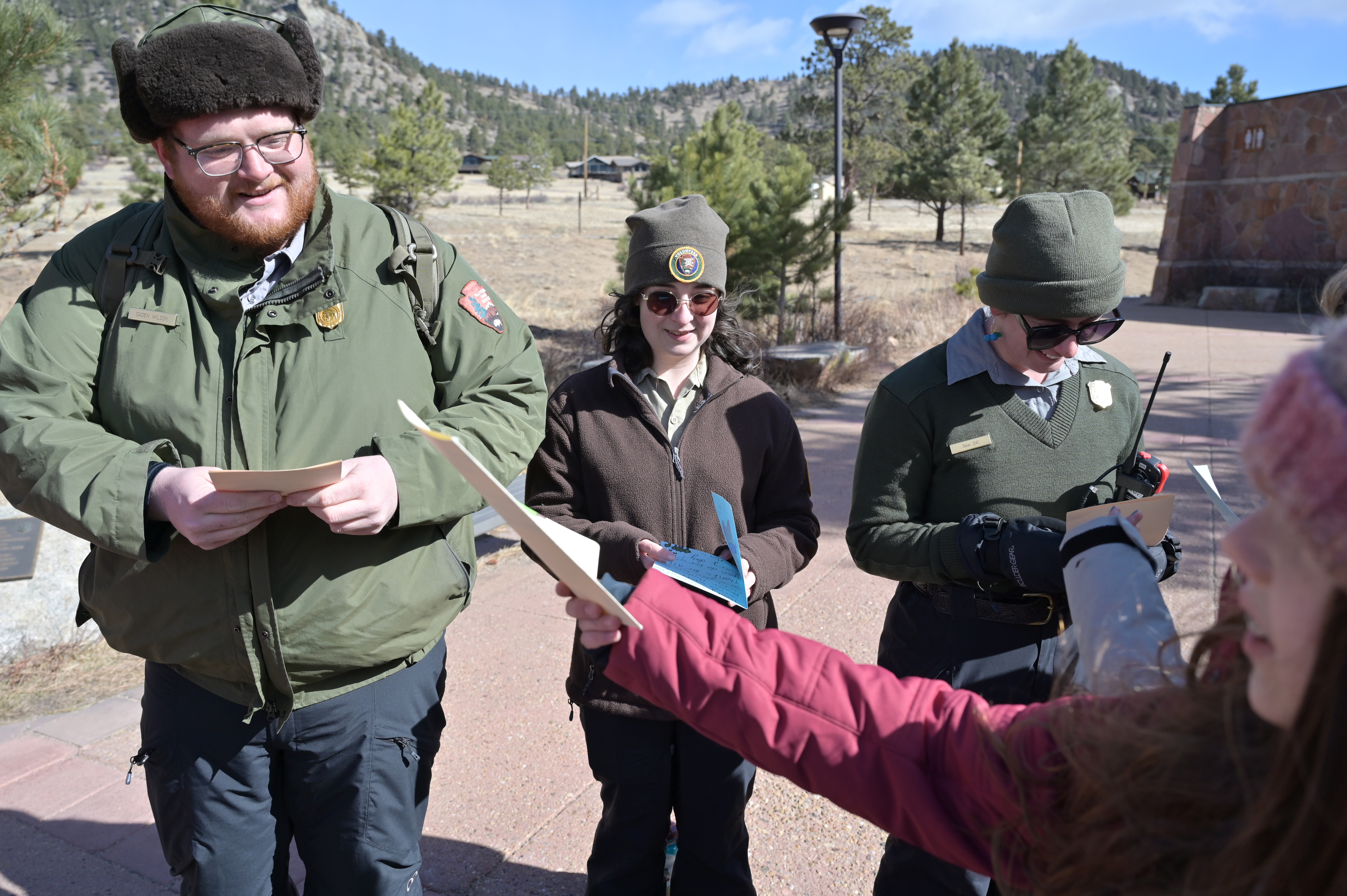 From left, park rangers Caden Wilson, Sarah Garcia and Belen del Valle Coello received cards from students at Rocky Mountain National Park's Beaver Meadows Visitor Center in Estes Park, Colorado, on Wednesday, March 5, 2025. In a heartfelt gesture of appreciation, 17 sixth-grade students from Shining Mountain Waldorf School have created personalized thank-you cards for National Park Service staff. (Photo by Hyoung Chang/The Denver Post)