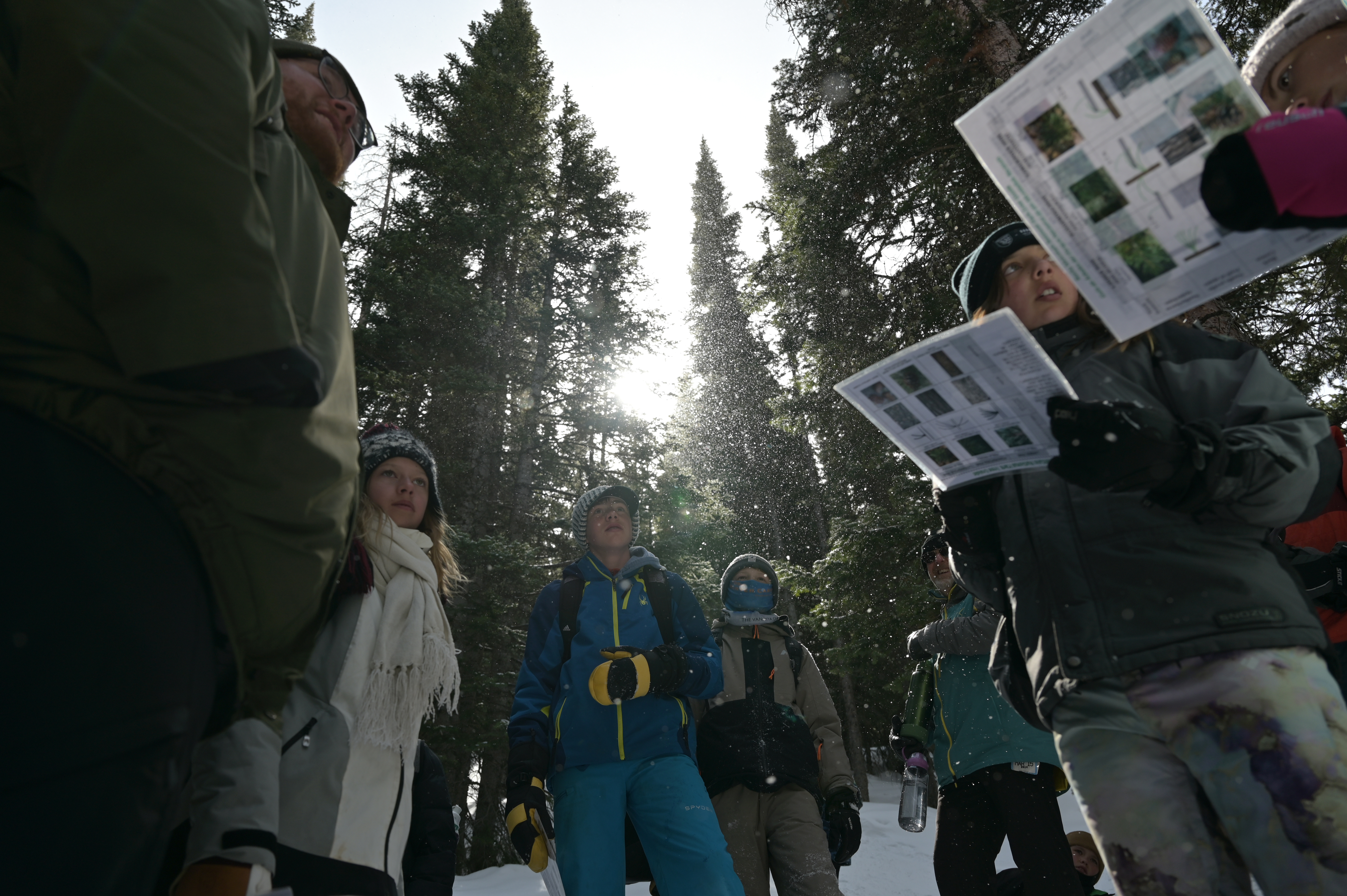 Park ranger Caden Wilson, left, and students snowshoe on Bear Lake Trail of Rocky Mountain National Park, Colorado, on Wednesday, March 5, 2025. In a heartfelt gesture of appreciation, 17 sixth-grade students from Shining Mountain Waldorf School have created personalized thank-you cards for National Park Service staff. Park rangers lead students on a hike as part of the school's Winter Ecology program. (Photo by Hyoung Chang/The Denver Post)