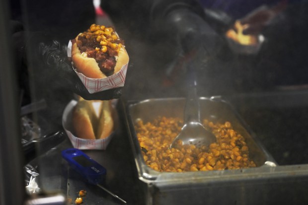 Zach Johnson prepares sausages at a Polidori Sausage stand at Coors Field in Denver on Friday, April 4, 2025. (Photo by Hyoung Chang/The Denver Post)