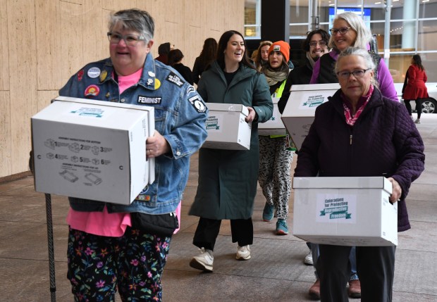 Supporters of Coloradans for Protecting Reproductive Freedom gather outside the Colorado Secretary of State's Office to deliver boxes filled with more than 200,000 voter signatures to put abortion rights on Colorado's November ballot on April 18, 2024, in Denver. (Photo By Kathryn Scott/Special to The Denver Post)