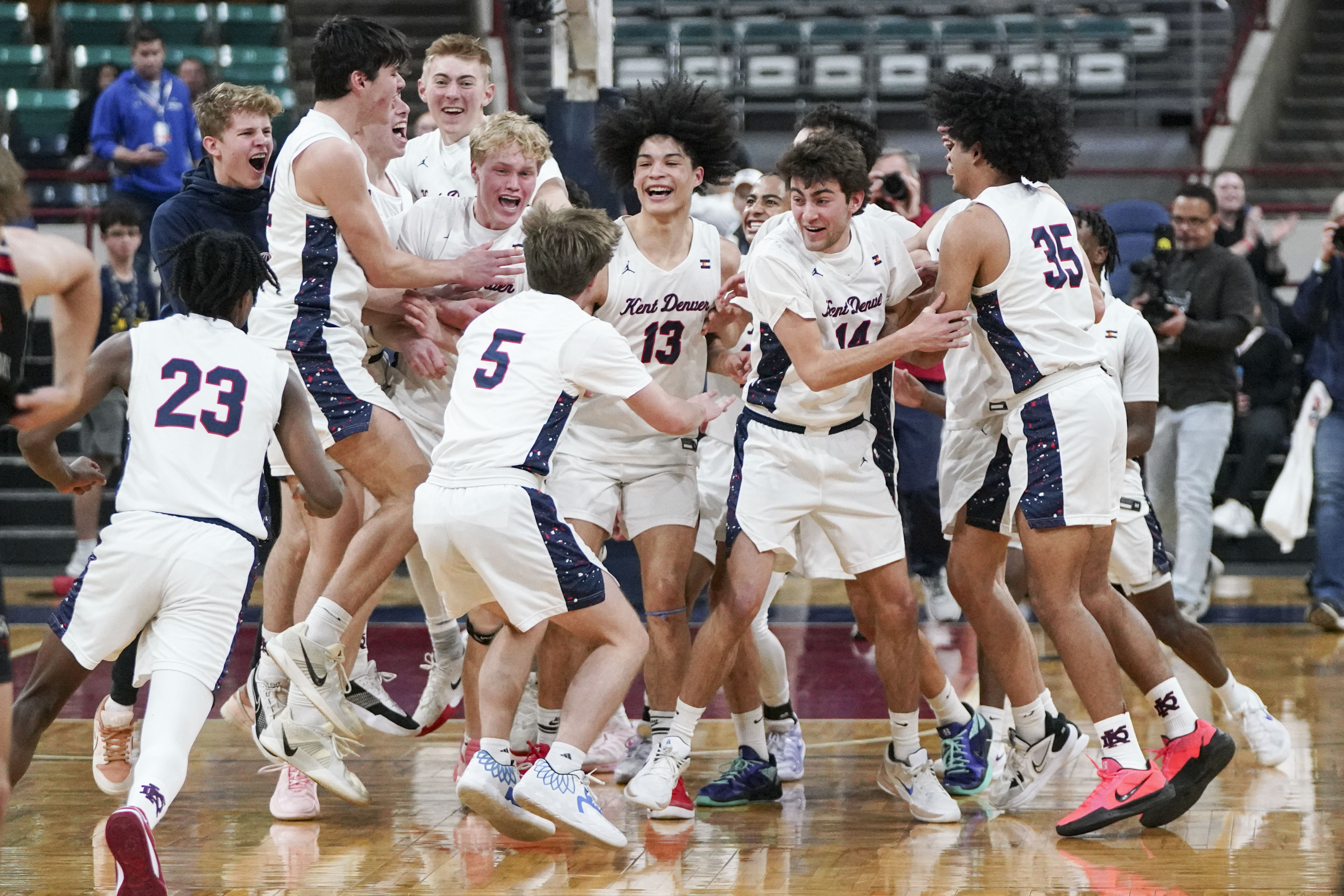 Kent Denver High School's Boy's Basketball team celebrates after winning the Colorado High School Boy's Basketball 4A State Championship game at Denver Coliseum, Saturday, March 15, 2025, in Denver. Kent Denver High School's Boy's Basketball team won 71-54. (Rebecca Slezak/Special to The Denver Post).