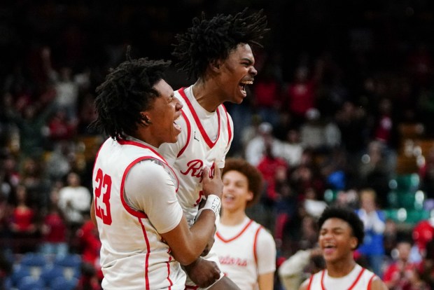 Eaglecrest's Anthony Nettles (1) and Eaglecrest's La'Quince York (23) celebrate on the court after winning the Class 6A Boy's Basketball State Championship game at Denver Coliseum, Saturday, March 15, 2025, in Denver. Eaglecrest High School's Boy's Basketball team won 65-63. (Rebecca Slezak/Special to The Denver Post).