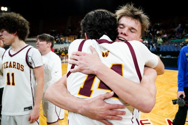 Windsor High School's Camden Smith (2) hugs Windsor High School's Marcus Martinez (14) after winning the Class 5A Boy's Basketball State Championship game at Denver Coliseum, Saturday, March 15, 2025, in Denver. Windsor won 60-49 against Green Mountain. (Rebecca Slezak/Special to The Denver Post).