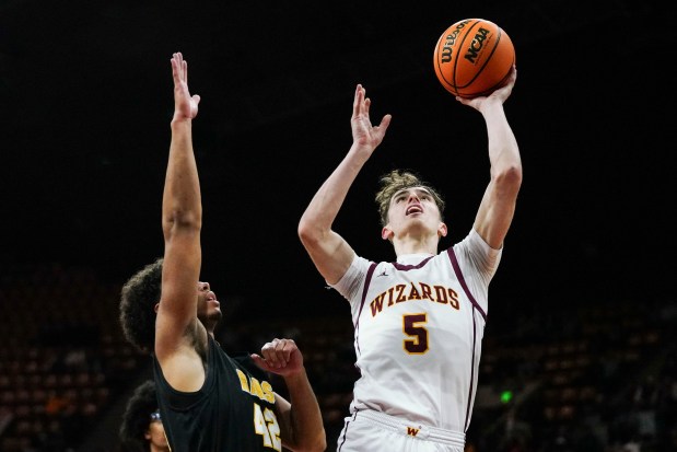 Windsor High School's Madden Smiley (5) shoots while defended by Green Mountain's Corbin Wade (42) during the Class 5A Boy's Basketball State Championship game at Denver Coliseum, Saturday, March 15, 2025, in Denver.Windsor won 60-49 against Green Mountain. (Rebecca Slezak/Special to The Denver Post).