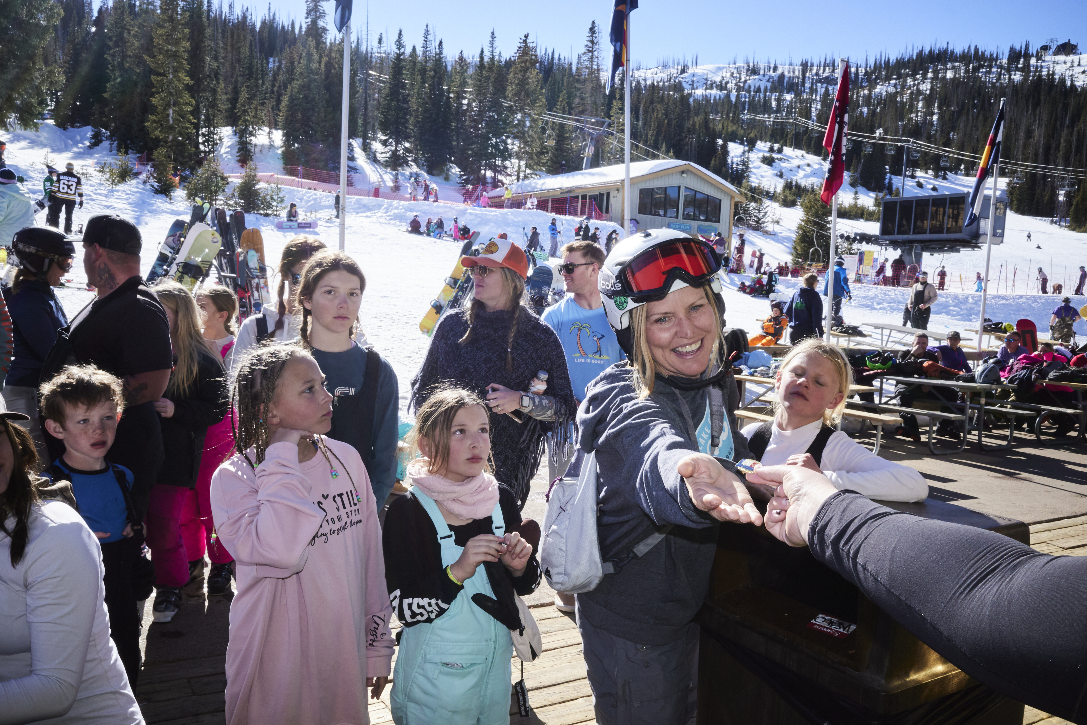 Holly Shephard receives a pendant for placing first in the Women's 41-50 age division in the Mardis Gras Fun Race at Wolf Creek Ski Area on March 1, 2025. (Photo by Jacob Spetzler/Special to The Denver Post)