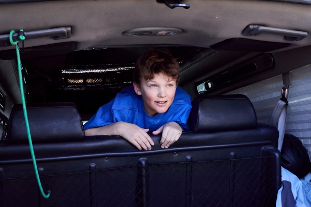Henry Shephard sticks his head over the back seats as his family loads skis after the Mardis Gras Fun Race at Wolf Creek Ski Area on March 1, 2025. (Photo by Jacob Spetzler/Special to The Denver Post)
